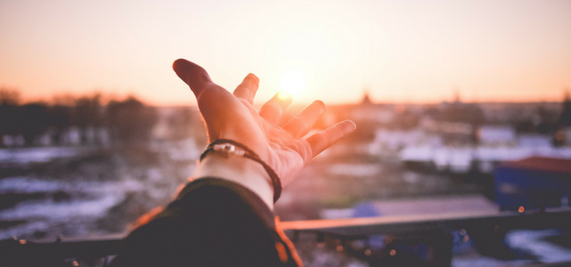 A woman's hand reaching out for the possibilities that can come from her circumstances, and that's resilience.