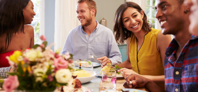 This woman is enjoying life with her friends at a dinner party since curcumin relieved her depression symptoms