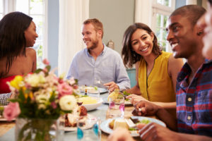 This woman is enjoying her friends at a dinner party because curcumin alleviated her depression