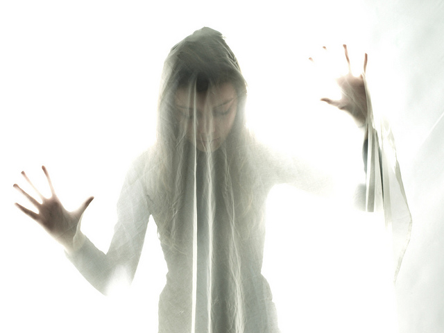 Woman with bipolar disorder appears to be under a veil because she feels veiled from her real self...and that no one can see who she really is.