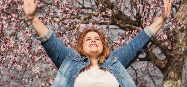 This lady raises her hands in gratefulness with an attitude of gratitude