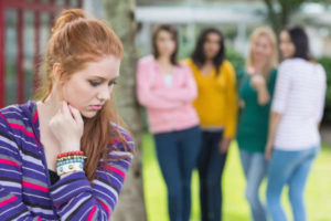 Shy teen feels left out and rejected by peer group. LoriCalabreseMD