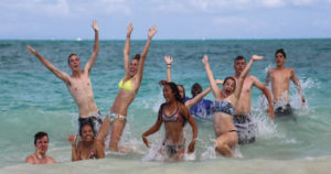 Teen playing in surf after treatment because teen exhibit signs of bipolar disorder.