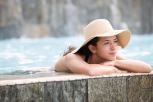 Woman lounges in pool free of OCD after obsessive compulsive disorder treatments change the game for her.