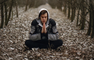 This young man sits alone in an isolated woody area because holidays with depressed family is so hard.