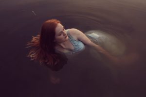 Depressed lady floating in water needs to know ketamine treatment erases suicidal thoughts.