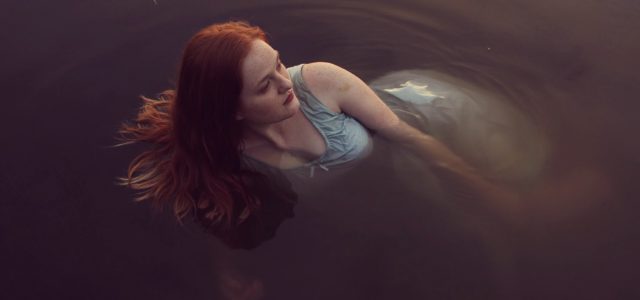 Depressed lady floating in water needs to know ketamine treatment erases suicidal thoughts.