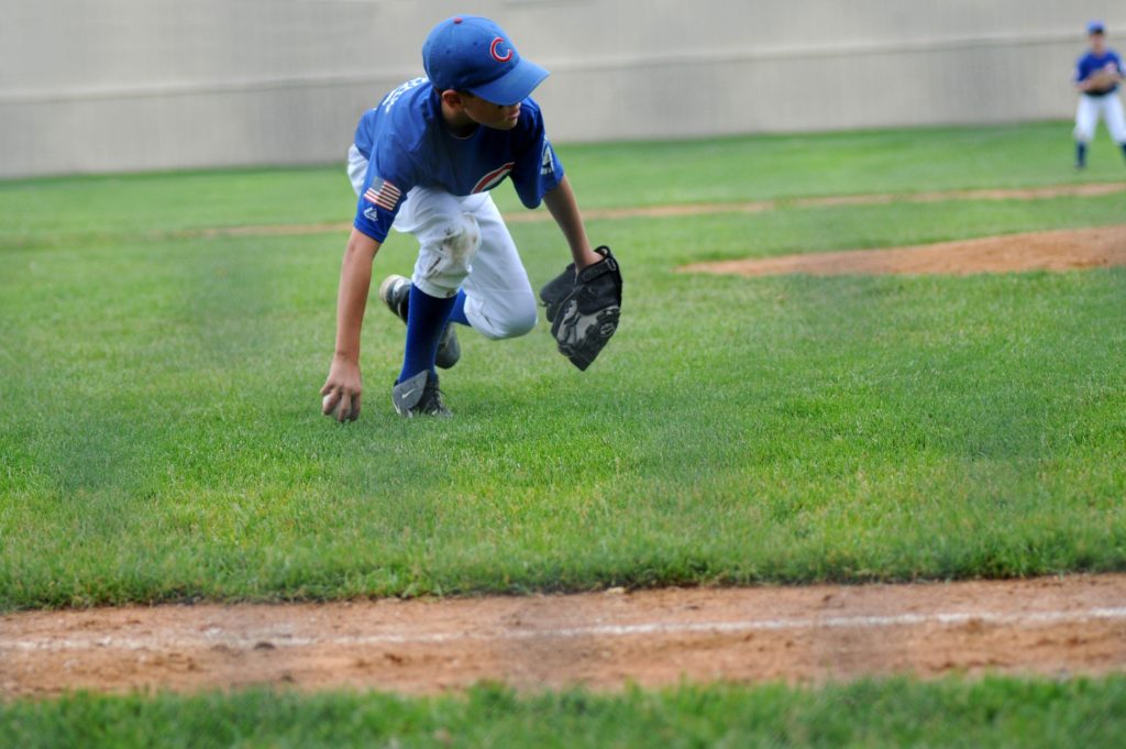 A healthy childhood may include a boy playing baseball like this boy.