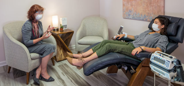 In this IV ketamine infusion room, Dr Calabrese speaks to a patient and the technology to remove viruses is shown to her left.